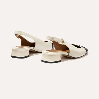 A cap toe low heel slingback with cream and black leather
