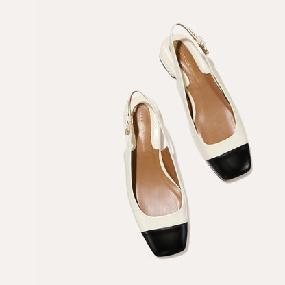 A cap toe low heel slingback with cream and black leather