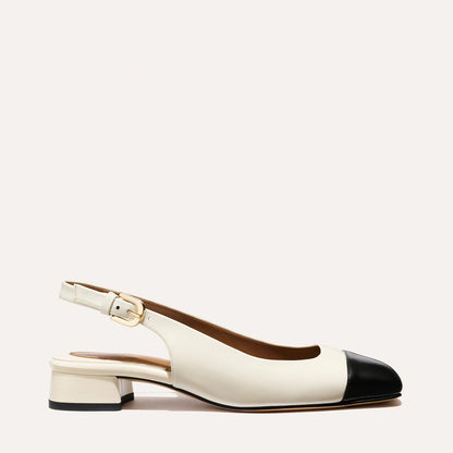 A cap toe low heel slingback with cream and black leather