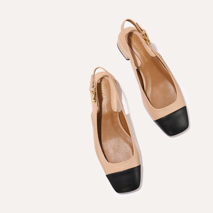 A cap toe low heel slingback neutral and black leather