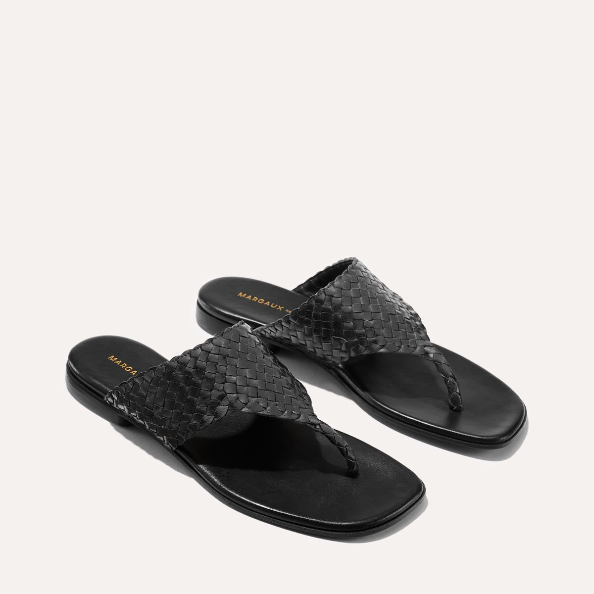 Black woven leather thong sandals