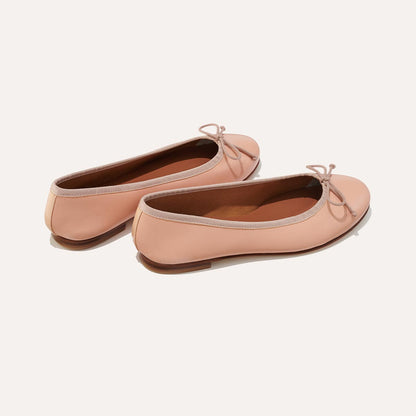 The Demi in Ballet Pink Nappa, a comfortable ballet flat with a rounded toe and adjustable cord bow detail.