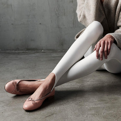 The Demi in Ballet Pink Nappa, a comfortable ballet flat with a rounded toe and adjustable cord bow detail.