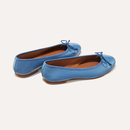 The Demi in cerulean blue nappa, a comfortable ballet flat with a rounded toe and adjustable cord bow detail.