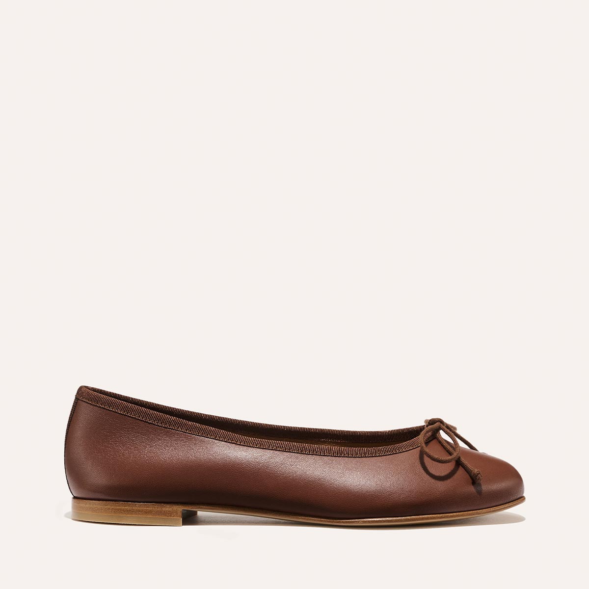 Handmade in Spain, The Demi - Cognac Nappa is a comfortable brown leather ballet flat featuring a small bow at the toe.