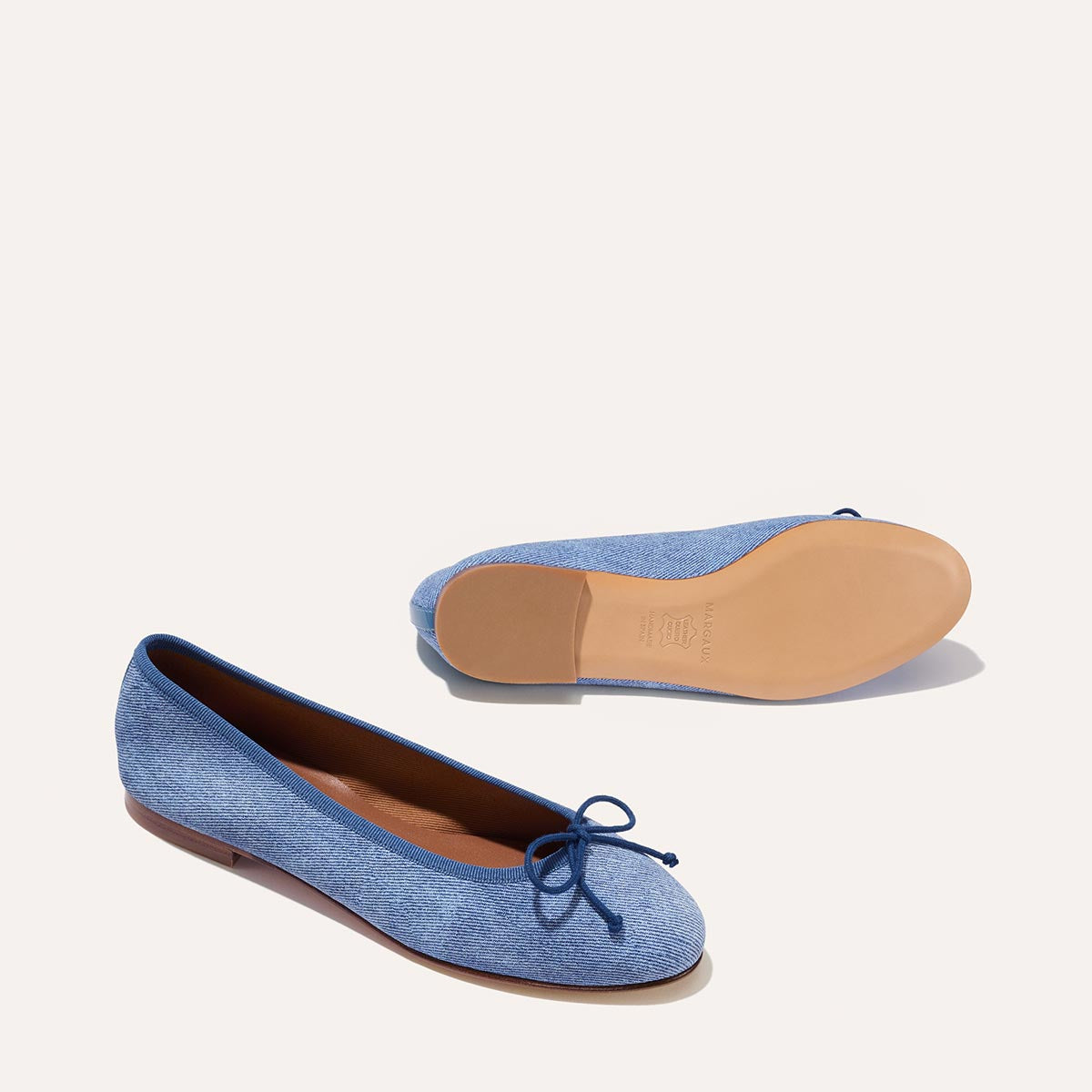 The Demi in soft Denim Suede, a comfortable ballet flat with a rounded toe and adjustable cord bow detail.