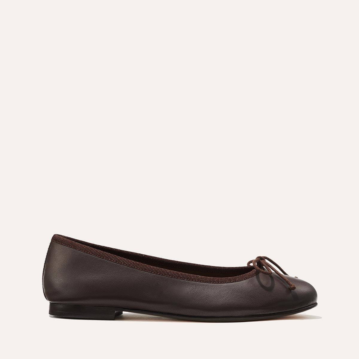 The Demi in Espresso Nappa, a comfortable ballet flat with a rounded toe and adjustable cord bow detail.