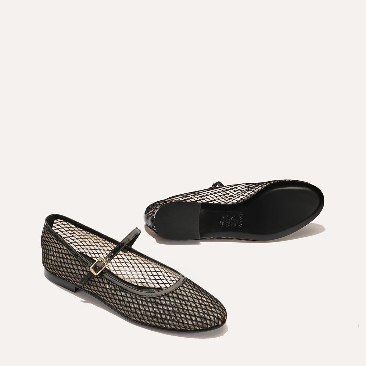 The Demi Jane in Black Fishnet Mesh, a sheer ballet flat with a rounded toe and an adjustable strap for a secure fit.