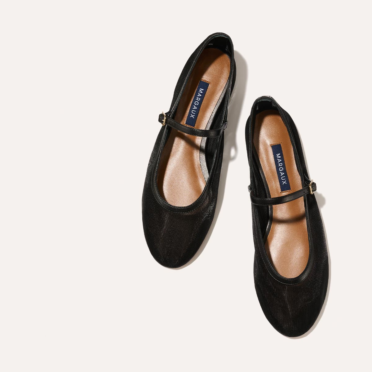 The Demi Jane in Black Mesh, a ballet flat with a rounded toe and an adjustable strap for a secure fit.