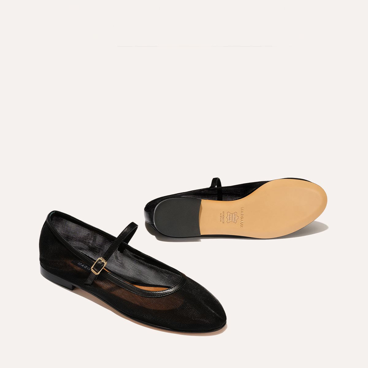 The Demi Jane in Black Mesh, a ballet flat with a rounded toe and an adjustable strap for a secure fit.