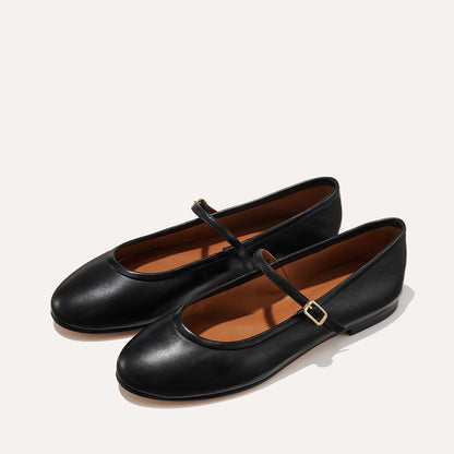 The Demi Jane in smooth Black Nappa, a ballet flat with a rounded toe and an adjustable strap for a secure fit.