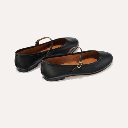 The Demi Jane in Black Nappa, a ballet flat with a rounded toe and an adjustable strap for a secure fit.