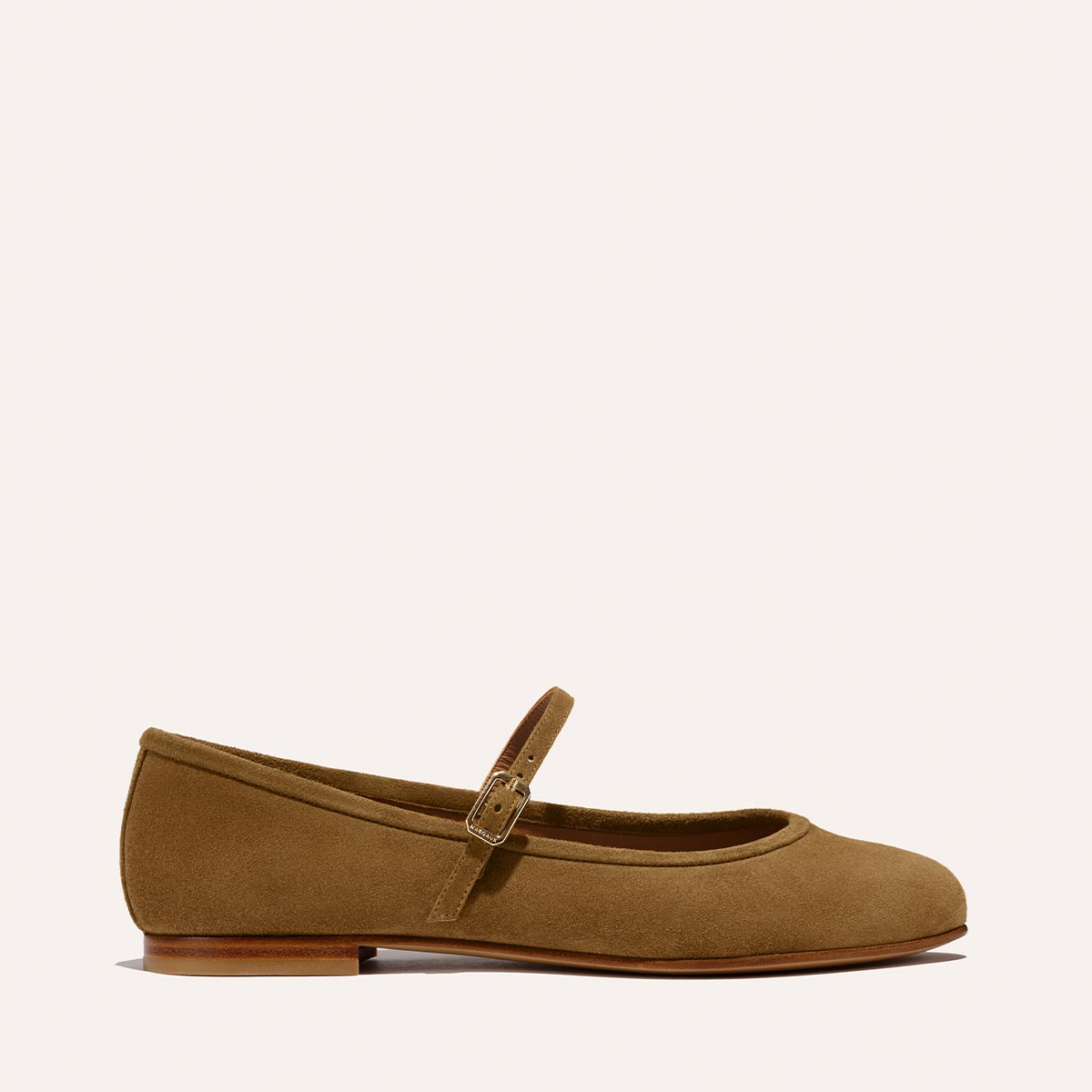 The Demi Jane - Cedar Suede by margaux-development is a tan suede Mary Jane flat with a rounded toe, slim buckled strap across the instep, and low heel, shown on a plain light background.