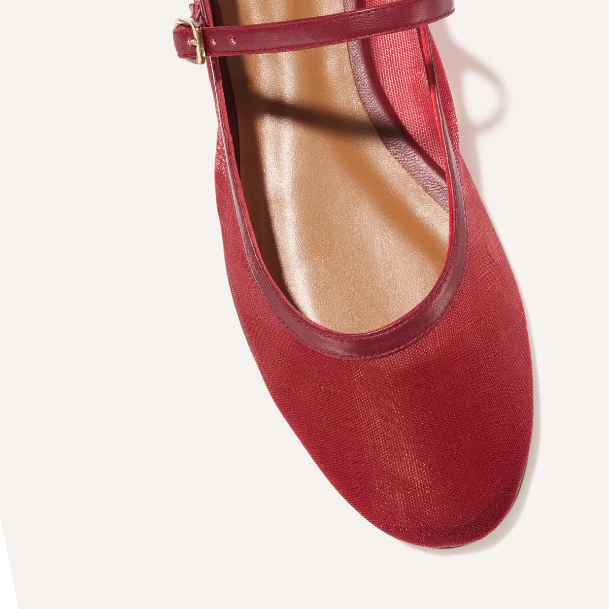 The Demi Jane in Crimson Mesh, a sheer ballet flat with a rounded toe and an adjustable strap for a secure fit.