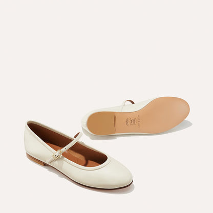 The Demi Jane in Ecru Nappa, a ballet flat with a rounded toe and an adjustable strap for a secure fit.