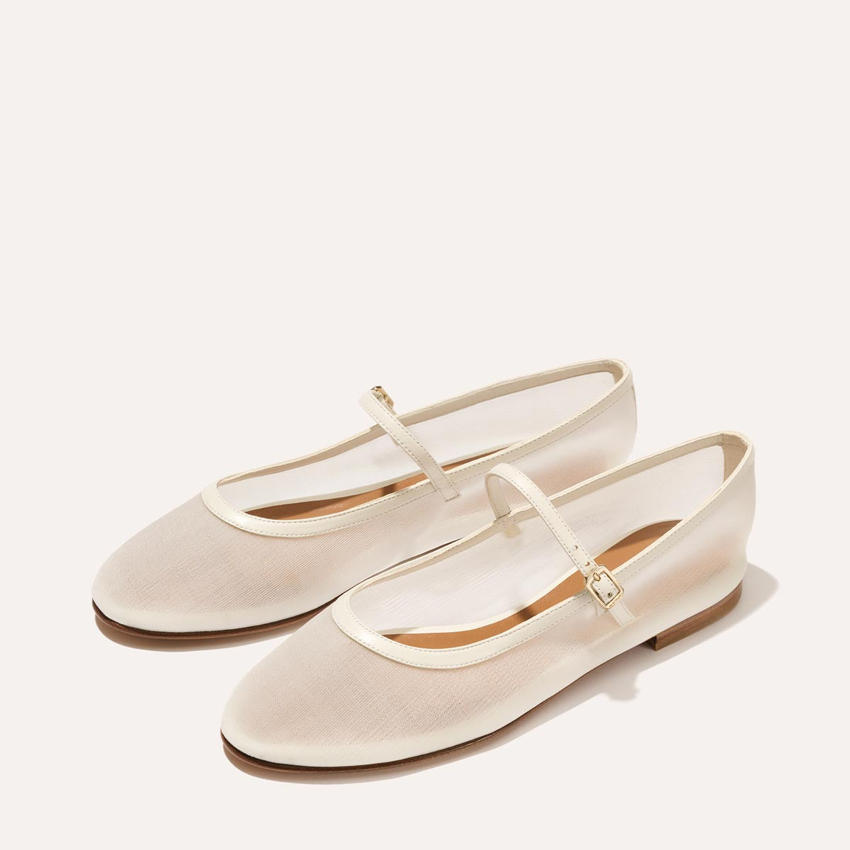 The Demi Jane in Ivory Mesh, a sheer ballet flat with a rounded toe and an adjustable strap for a secure fit.