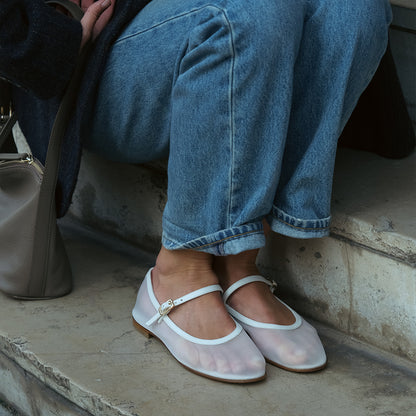 The Demi Jane in Ivory Mesh, a sheer ballet flat with a rounded toe and an adjustable strap for a secure fit.