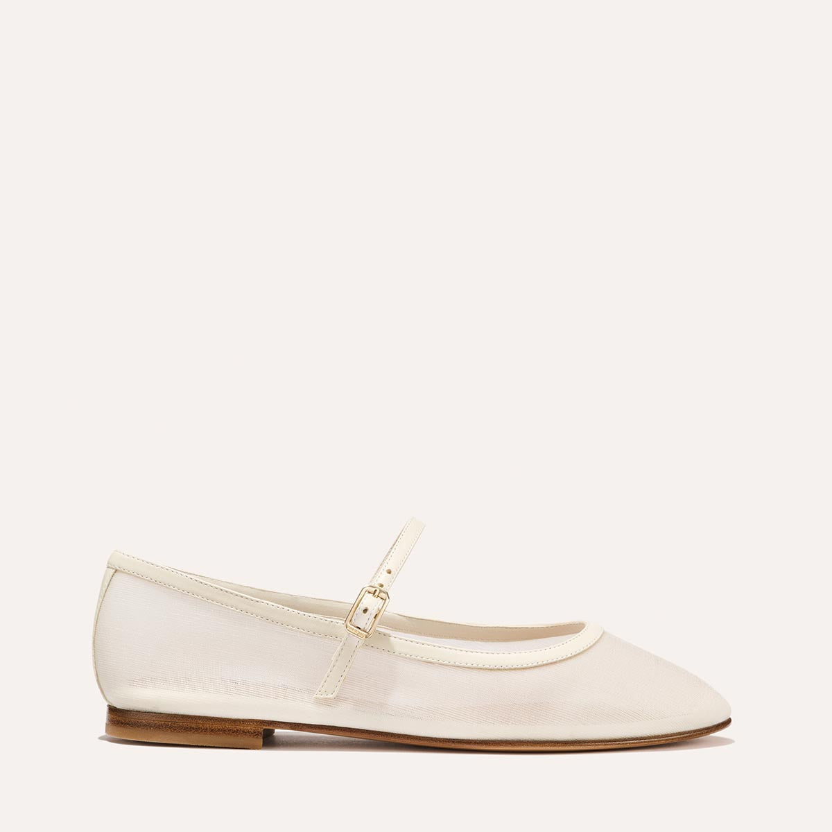 The Demi Jane in Ivory Mesh, a sheer ballet flat with a rounded toe and an adjustable strap for a secure fit.