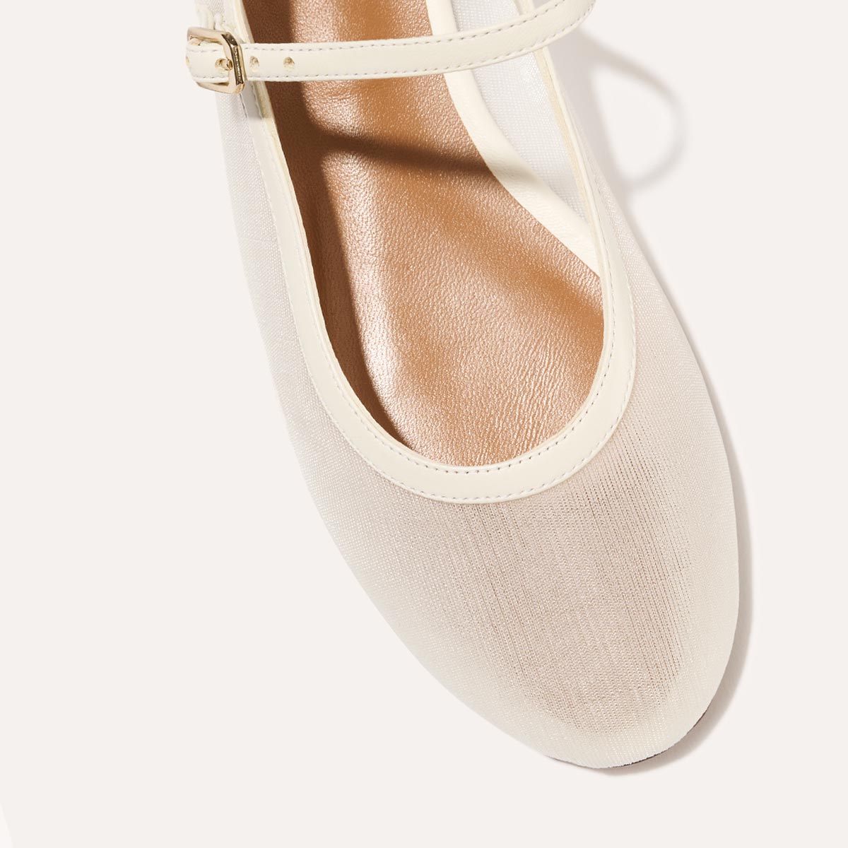 The Demi Jane in Ivory Mesh, a sheer ballet flat with a rounded toe and an adjustable strap for a secure fit.