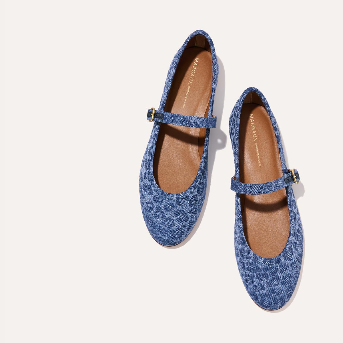 The Demi Jane in blue Leopard Denim, a ballet flat with a rounded toe and an adjustable strap for a secure fit.