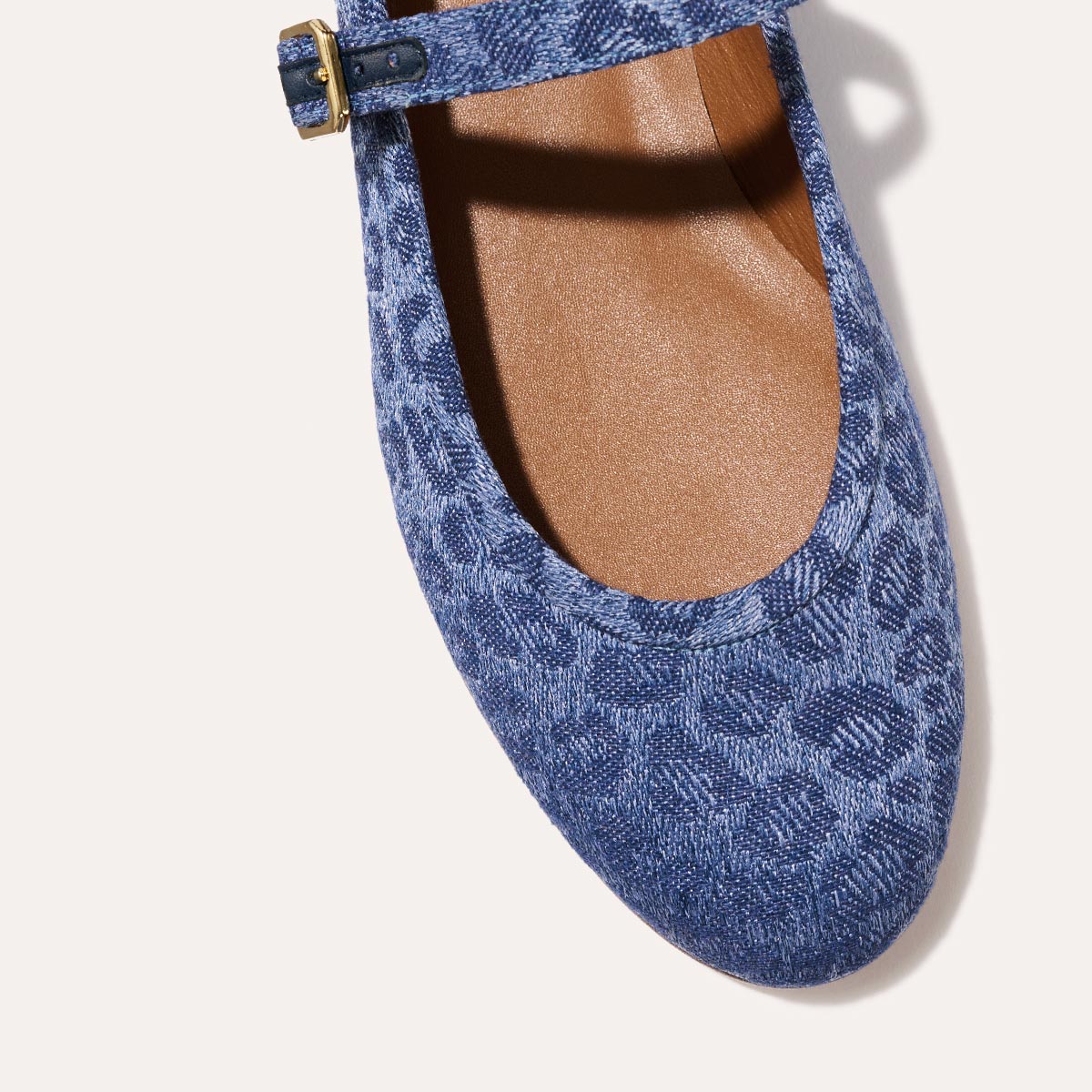 The Demi Jane in blue Leopard Denim, a ballet flat with a rounded toe and an adjustable strap for a secure fit.