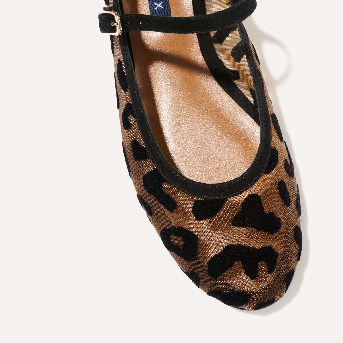 The Demi Jane in Leopard Mesh, a ballet flat with a rounded toe and an adjustable strap for a secure fit.