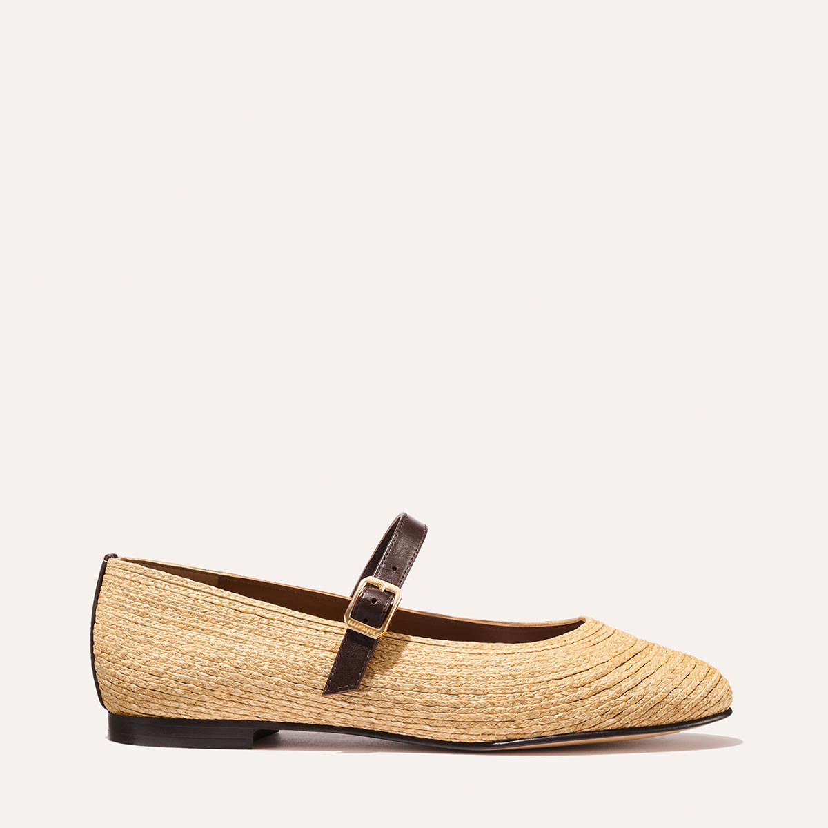 The Demi Jane in natural raffia, a ballet flat with a rounded toe and an adjustable strap for a secure fit.