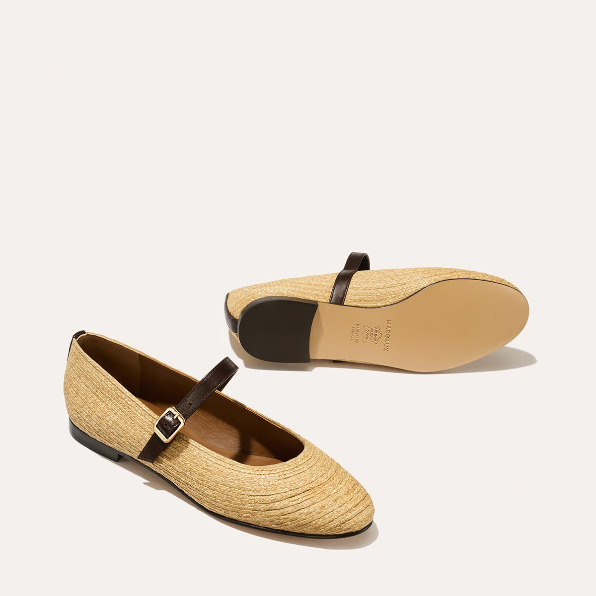 The Demi Jane in natural raffia, a ballet flat with a rounded toe and an adjustable strap for a secure fit.