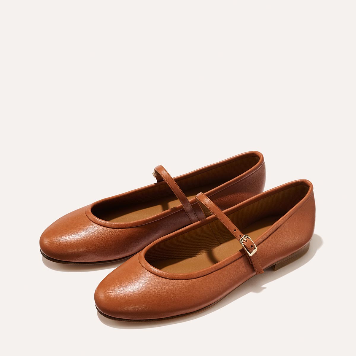 The Demi Jane in buttery soft Saddle Nappa, a ballet flat with a rounded toe and an adjustable strap for a secure fit.