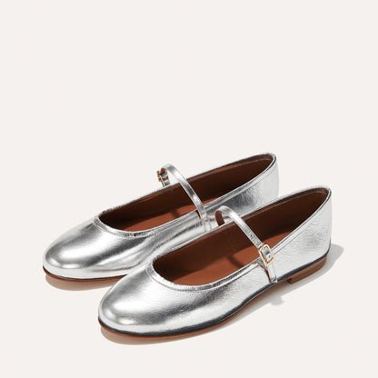 The Demi Jane in metallic Silver Crinkle Mirror, a ballet flat with a rounded toe and an adjustable strap for a secure fit.