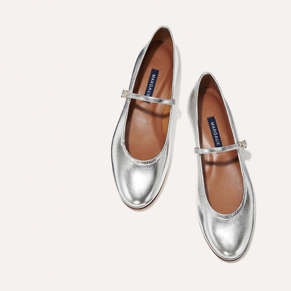 The Demi Jane in metallic Silver Crinkle Mirror, a ballet flat with a rounded toe and an adjustable strap for a secure fit.