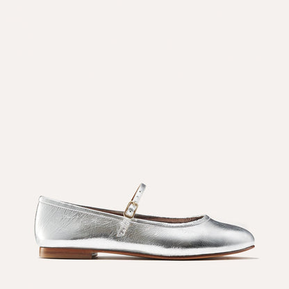 The Demi Jane in metallic Silver Crinkle Mirror, a ballet flat with a rounded toe and an adjustable strap for a secure fit.