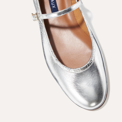 The Demi Jane in metallic Silver Crinkle Mirror, a ballet flat with a rounded toe and an adjustable strap for a secure fit.