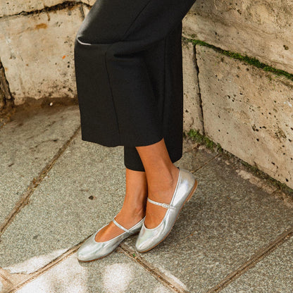 The Demi Jane in metallic Silver Crinkle Mirror, a ballet flat with a rounded toe and an adjustable strap for a secure fit.