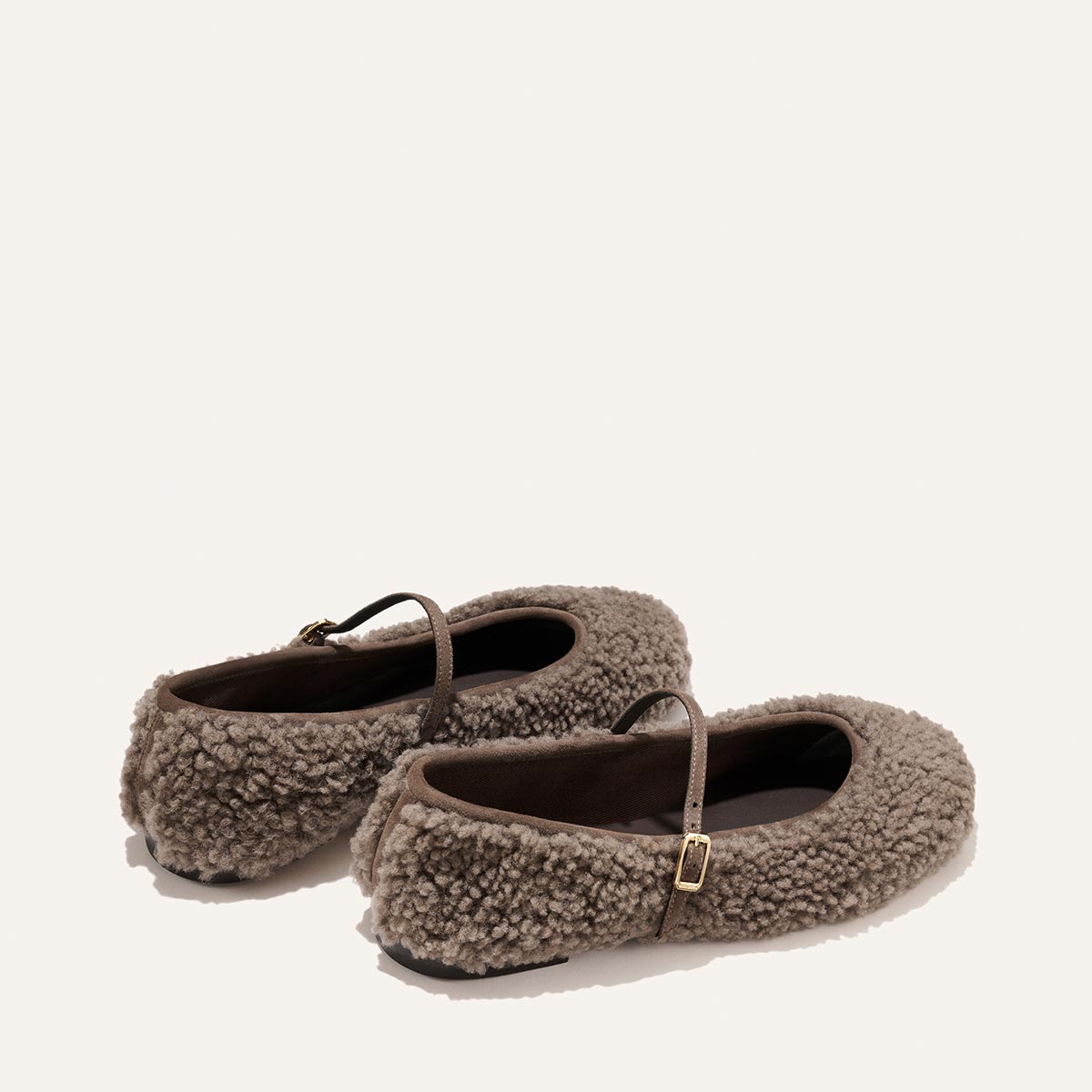 The Demi Jane - Taupe Shearling Mary Jane flats feature thin buckled straps, embodying elegant femininity.