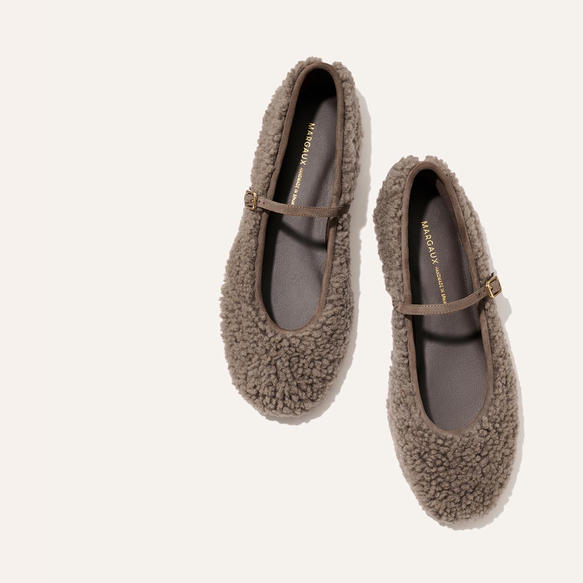 Margaux The Demi Jane - Taupe Shearling flats with a thin strap and gold buckle.