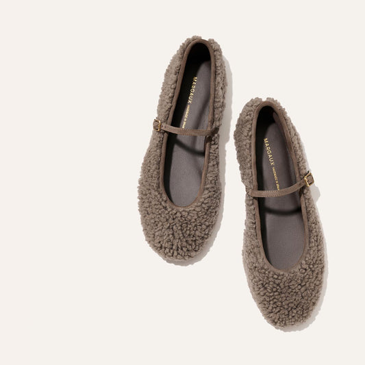 Margaux The Demi Jane - Taupe Shearling flats with a thin strap and gold buckle.