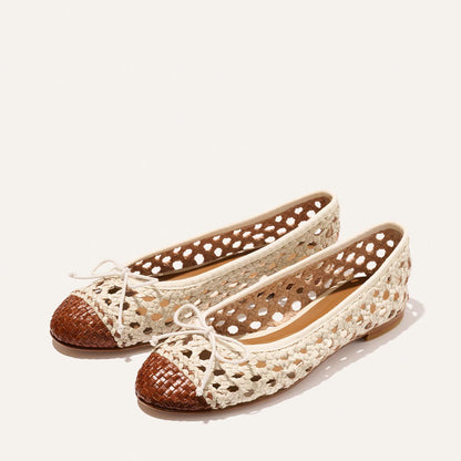 The Demi - Ecru and Saddle Woven Leather by Margaux features cream woven sides, lace-up bows, and brown closed toe caps. Displayed on a light background.
