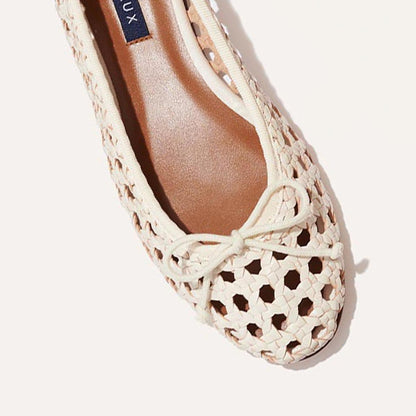 Top view of The Demi - Ecru Woven ballet flat by margaux-development: cream woven leather, rounded toe, front bow, and a breathable lattice design highlighting Spanish artisanal craftsmanship. Part of the inner label is visible.