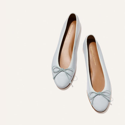 The Demi - Mist Blue Nappa by Margaux: comfortable ballet flats in light blue with small toe bows, handmade in Spain and shown on a plain light background.
