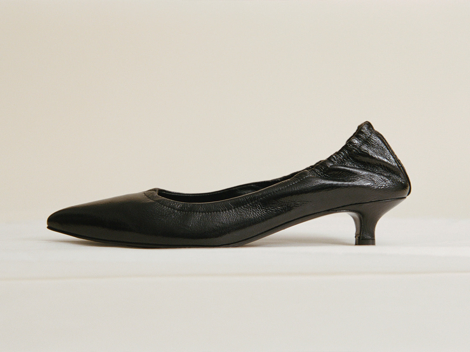 Black shoe on a beige background