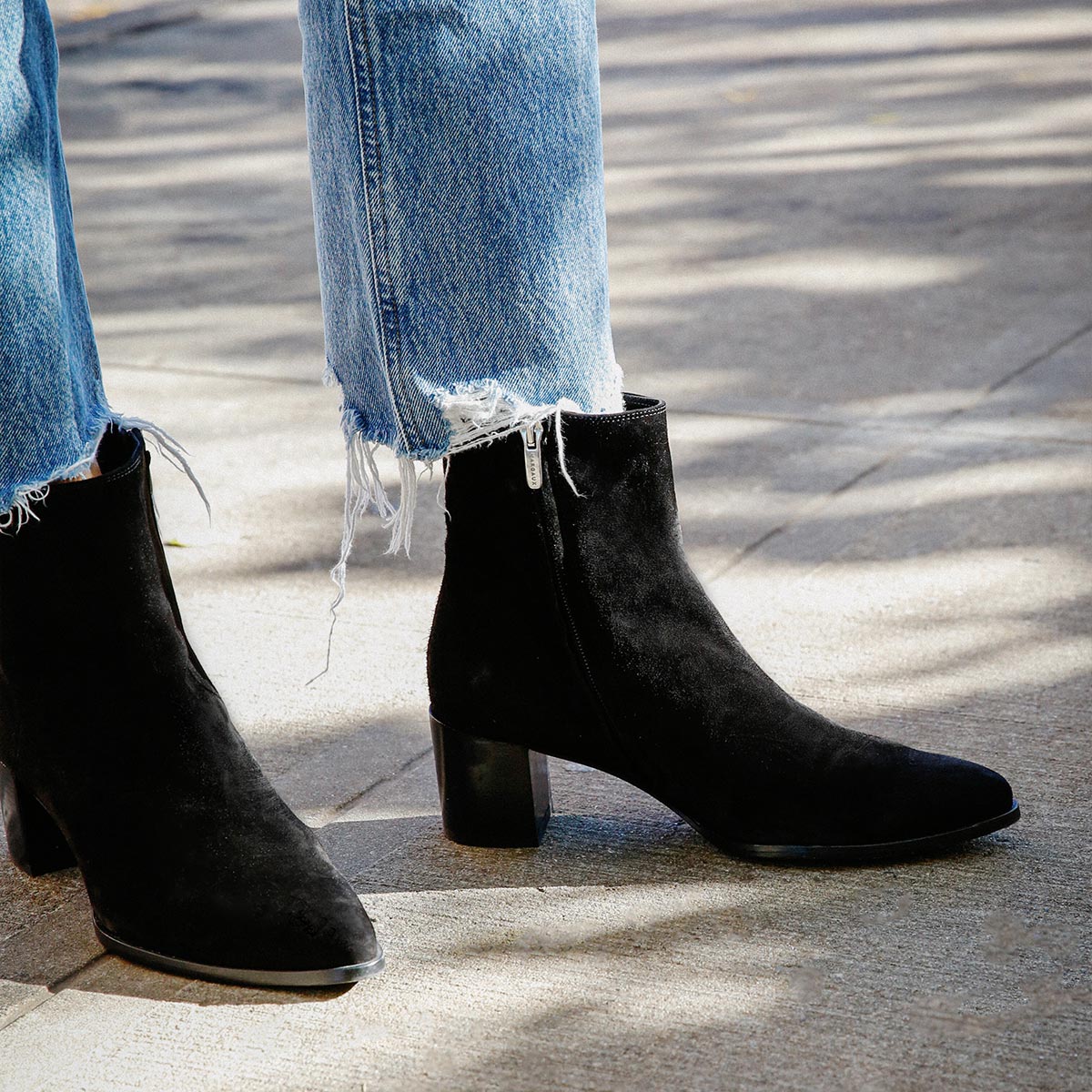 The Downtown Boot in Black Suede, a chic ankle-height design complete with a Western-inspired welt and a comfortable 2.5-inch stacked heel.