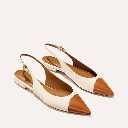 The Elise by margaux-development: women's slingback flats with pointed toes, tan brown toe cap and heel, cream sides and ankle straps—crafted in Cotton and Saddle Nappa, shown on a light background.