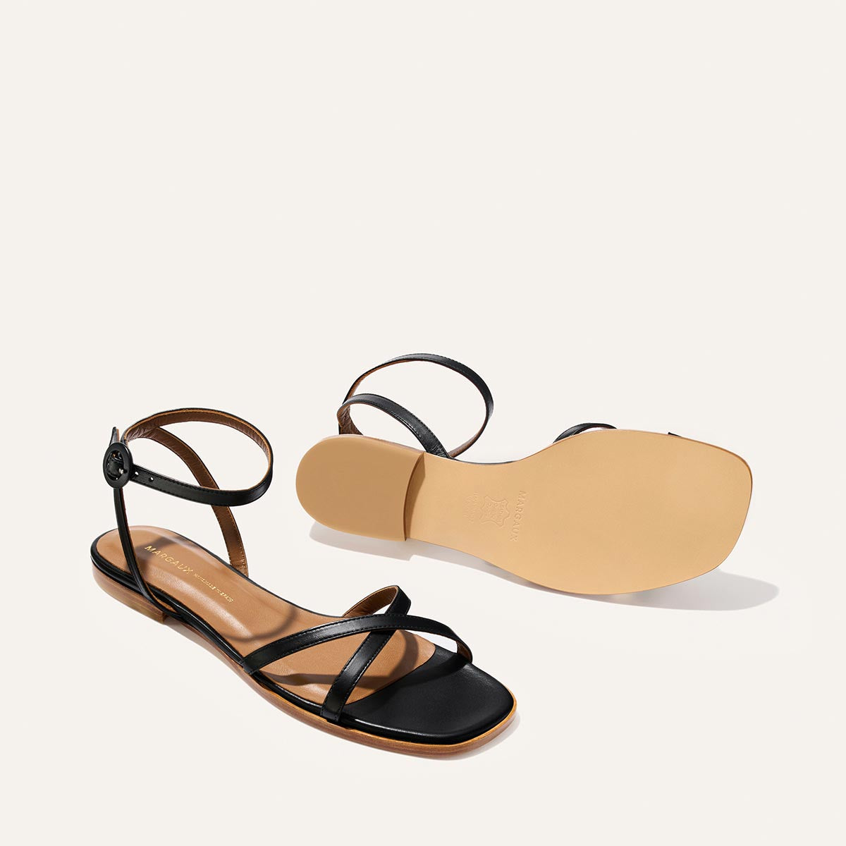 Black strappy sandal on a white background
