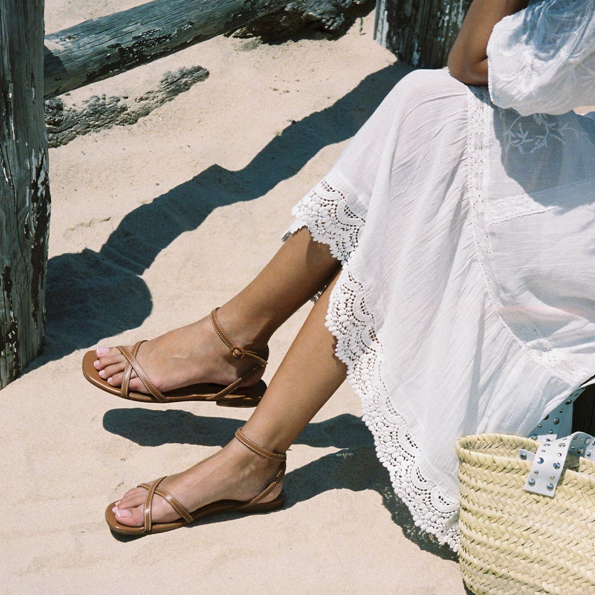 The Flat Sandal in saddle brown nappa, a minimal sandal featuring thin, flattering straps with a subtly square toe.