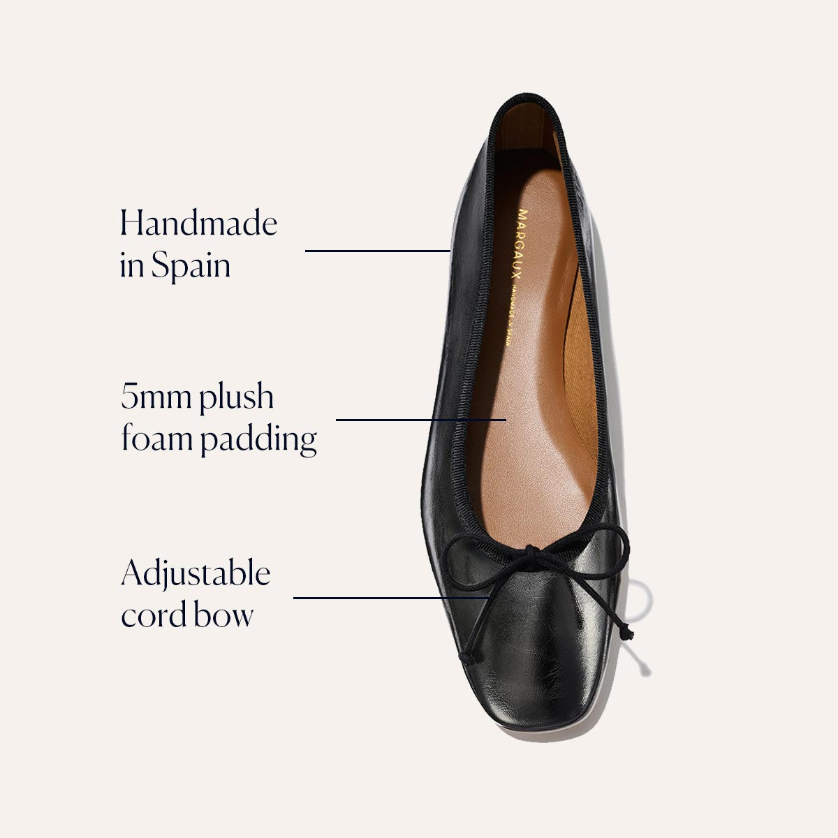 The Fonteyn - Black Crinkle-Gloss Nappa by Margaux is a handcrafted ballet flat from Spain, featuring 5mm plush foam padding for comfort, an adjustable cord bow, a rounded toe, and an elegant, simple design.