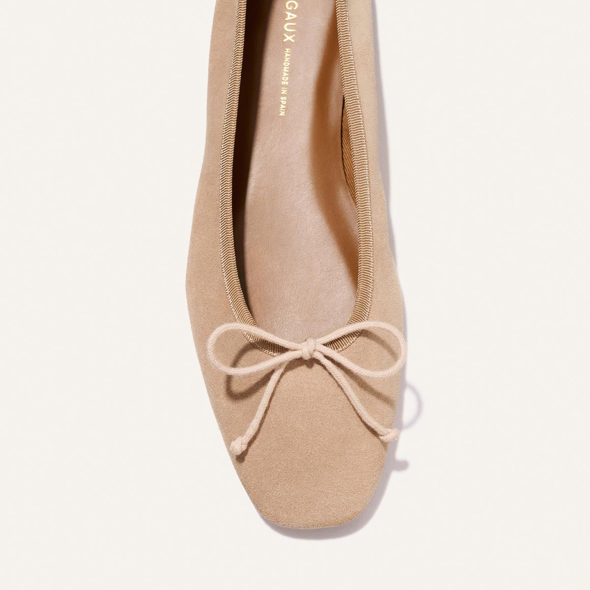 The Fonteyn - Cameo Suede by Margaux: a beige suede ballet flat with a square toe and simple bow, shown from above on a white background.