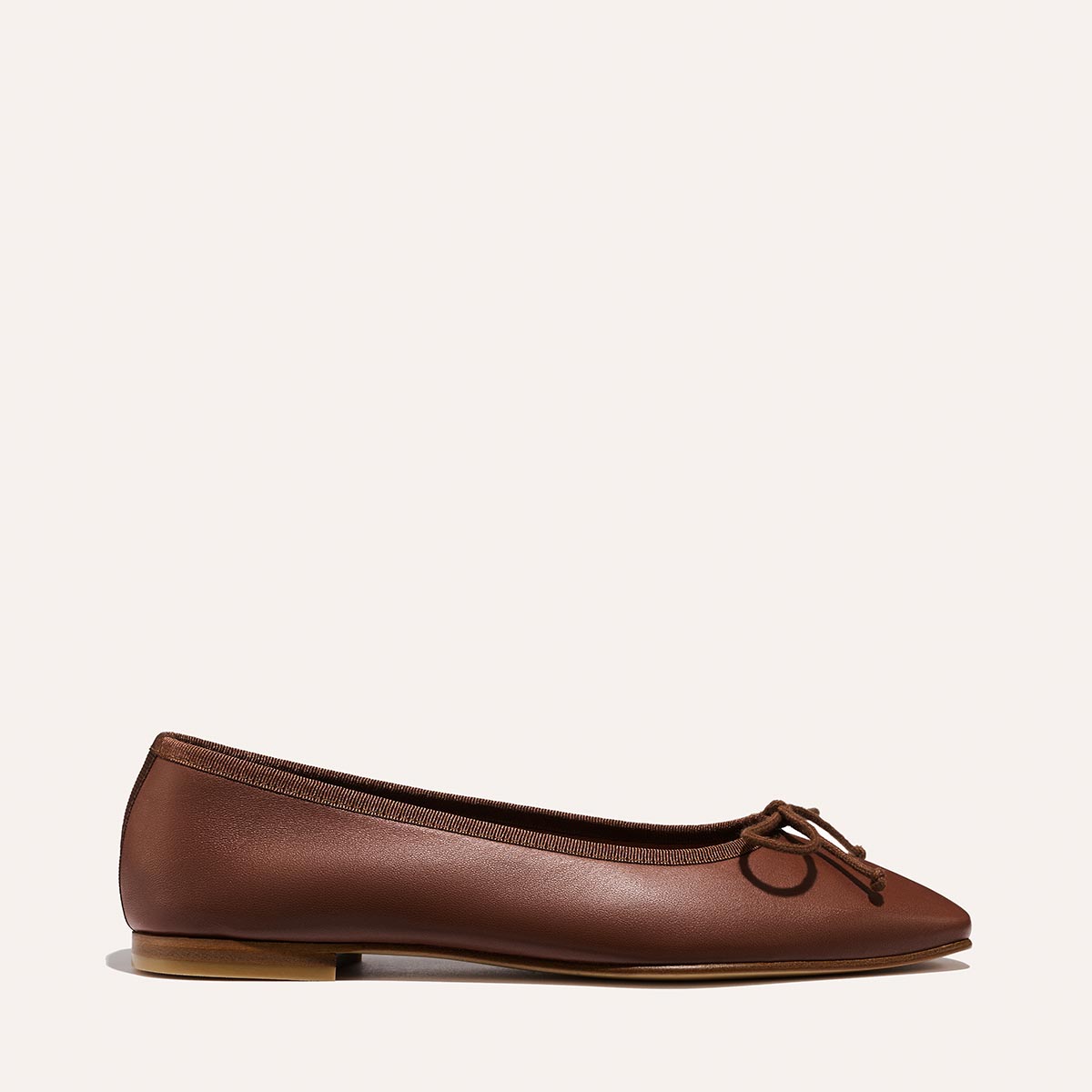 The Fonteyn - Cognac Nappa brown leather ballet flat with a chic squared-off toe and a small bow at the front.