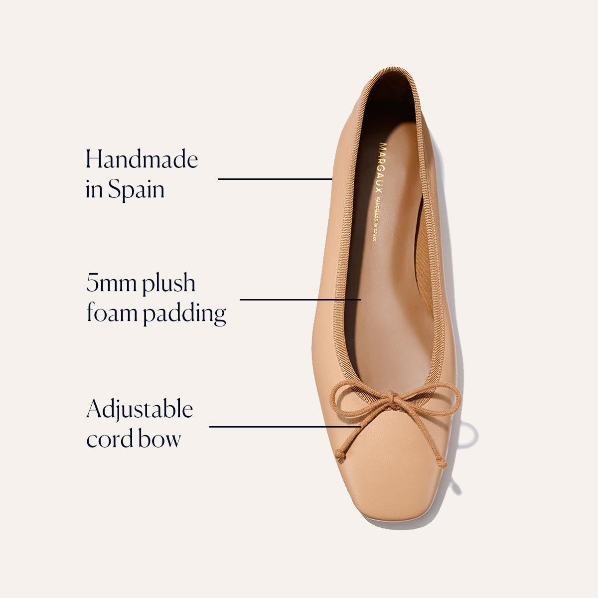 The Margaux Fonteyn - Dune Nappa is a handcrafted tan ballet flat made in Spain, featuring 5mm plush foam padding and an adjustable cord bow for comfort. Pictured from above on a neutral background.