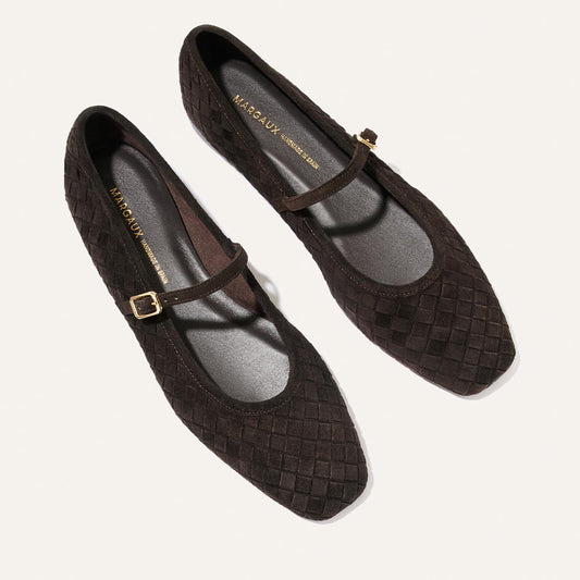 A pair of The Fonteyn Jane flats by Margaux in dark chocolate woven pasado suede, featuring pointed toes and a single strap with a small gold buckle, displayed on a light background.